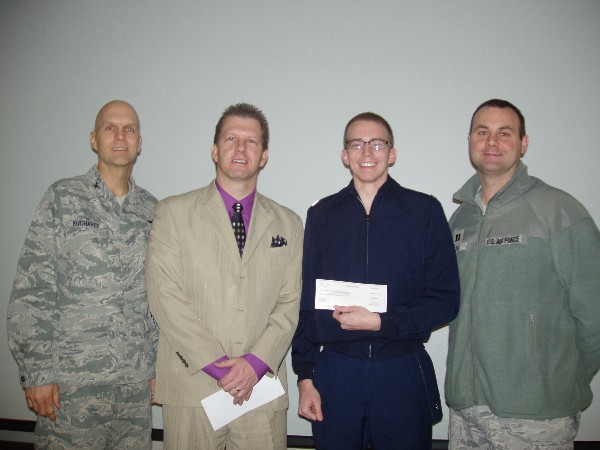 In January, Cadet Charles Connors, Air Force ROTC (2nd from r), Detachment 855, Brigham Young University, receives a scholarship from Col. Paul Kucharek, USAF (l), commander; Capt. Richard Hart, USAF, recruiting flight commander; and Martin.